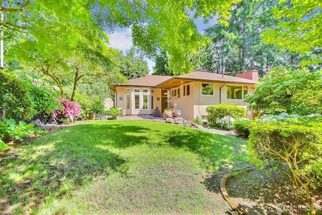 2404 SW 170th St, Burien, WA 98166 - back of property with a chimney and a yard