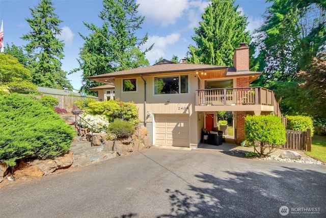 2404 SW 170th St, Burien, WA 98166 - view of front of house with an attached garage, asphalt driveway, and a chimney