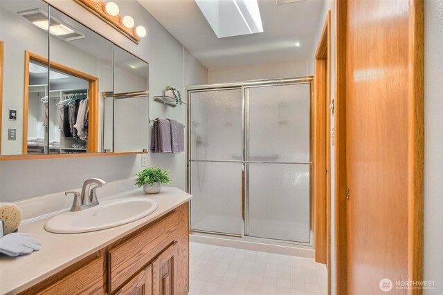 2404 SW 170th St, Burien, WA 98166 - bathroom with a stall shower, vanity, a walk in closet, and a skylight