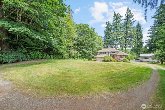 16714 Broadway Ave, Snohomish, WA 98296 - view of grassy yard featuring a garage and driveway