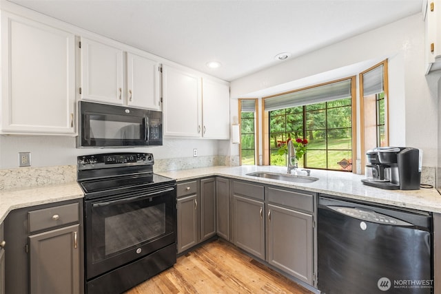 16714 Broadway Ave, Snohomish, WA 98296 - kitchen featuring black appliances, gray cabinetry, light wood finished floors, light stone counters, and white cabinets
