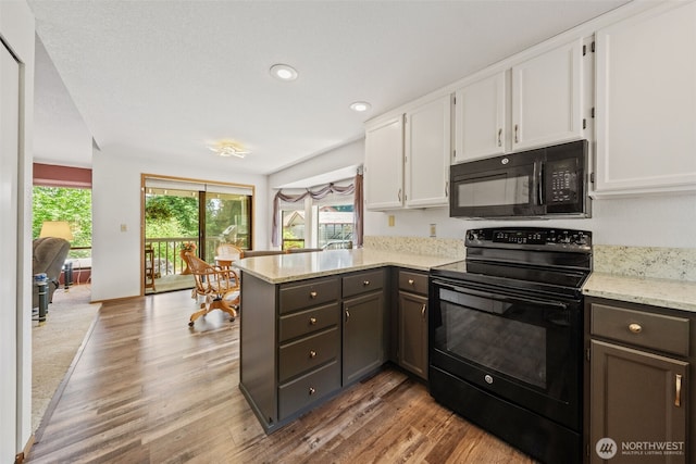 16714 Broadway Ave, Snohomish, WA 98296 - kitchen with black appliances, a peninsula, white cabinetry, wood finished floors, and recessed lighting