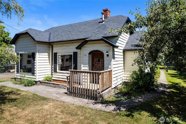 136 D St, Buckley, WA 98321 - view of front of property with a chimney, roof with shingles, and an attached garage