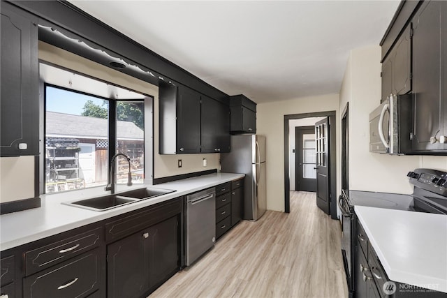 136 D St, Buckley, WA 98321 - kitchen with stainless steel appliances, light countertops, light wood finished floors, and dark cabinets