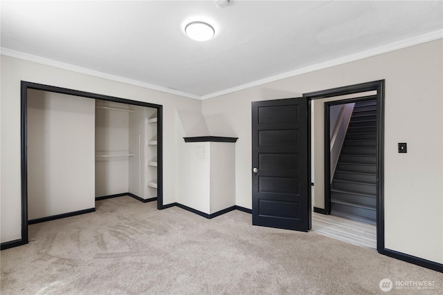 136 D St, Buckley, WA 98321 - unfurnished bedroom featuring light carpet, crown molding, and a closet