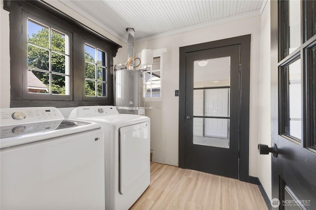 136 D St, Buckley, WA 98321 - washroom featuring water heater, washer and dryer, a chandelier, ornamental molding, and light wood-style flooring