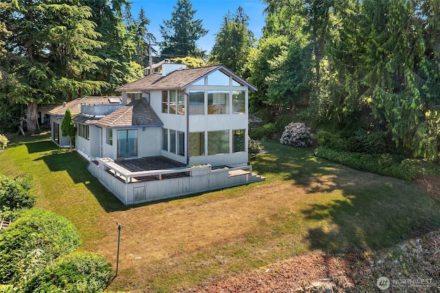 10634 SW Cowan Rd, Vashon, WA 98070 - rear view of property with a sunroom, stucco siding, and a yard