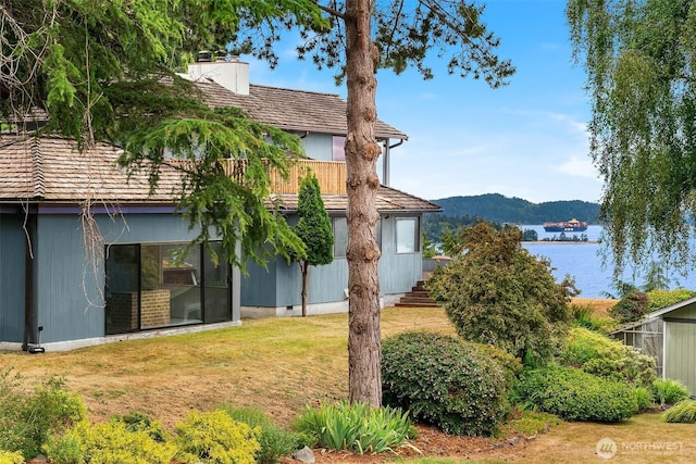 10634 SW Cowan Rd, Vashon, WA 98070 - view of green lawn with a balcony and a water view