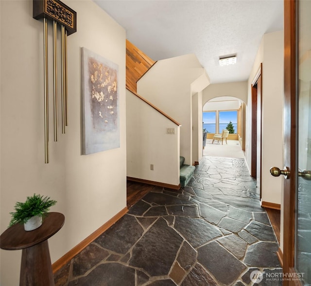 10634 SW Cowan Rd, Vashon, WA 98070 - hallway with stone floors and arched walkways