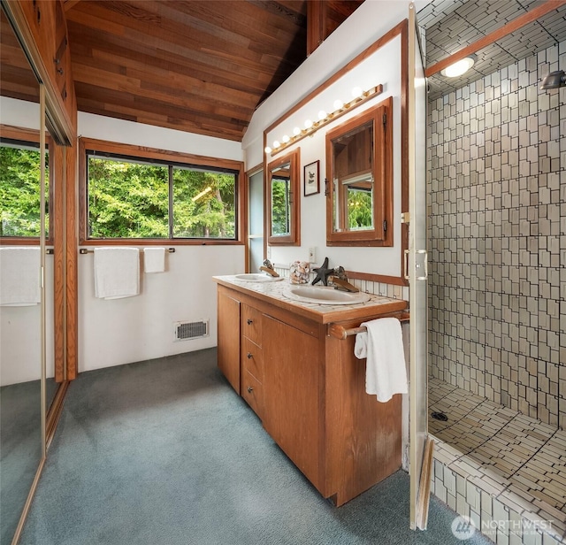 10634 SW Cowan Rd, Vashon, WA 98070 - bathroom featuring a shower stall, double vanity, and vaulted ceiling