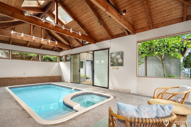 10634 SW Cowan Rd, Vashon, WA 98070 - view of swimming pool featuring a skylight and a pool with connected hot tub