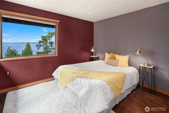 10634 SW Cowan Rd, Vashon, WA 98070 - bedroom featuring wood finished floors and a water view