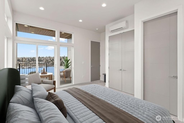 2921 Franklin Ave E Unit B, Seattle, WA 98102 - bedroom with a wall mounted AC, access to exterior, a water view, recessed lighting, and light colored carpet