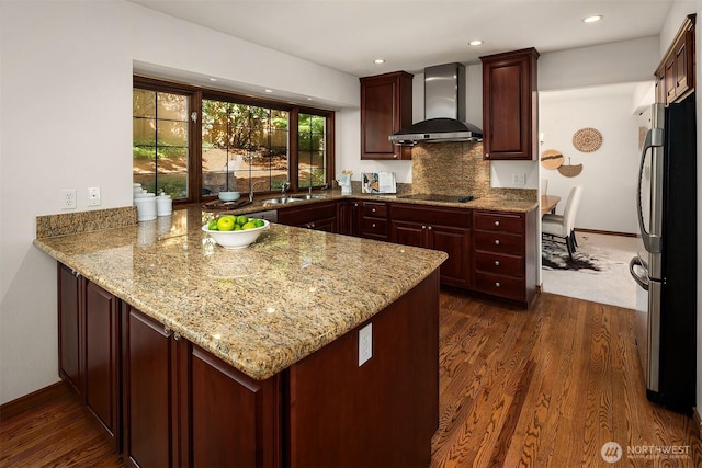 6220 146th Pl SE, Bellevue, WA 98006 - kitchen featuring wall chimney range hood, freestanding refrigerator, a peninsula, dark wood-type flooring, and light stone counters