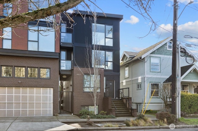 4422 Woodlawn Ave N Unit 213, Seattle, WA 98103 - view of front facade featuring brick siding and concrete driveway