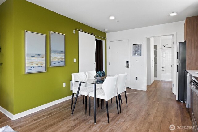 4422 Woodlawn Ave N Unit 213, Seattle, WA 98103 - dining area with wood finished floors and baseboards