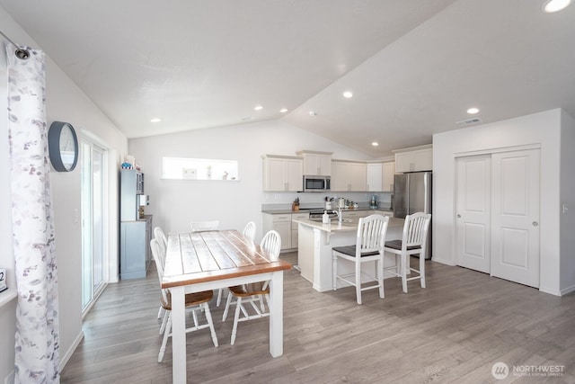 1205 W Sequoia Rd, Moses Lake, WA 98837 - dining space with lofted ceiling, light wood-style floors, and recessed lighting