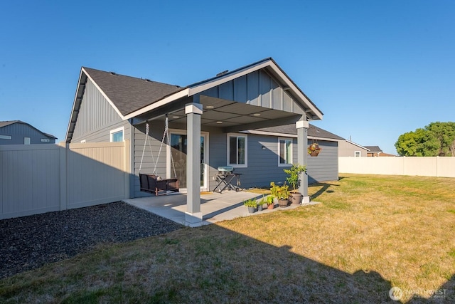 1205 W Sequoia Rd, Moses Lake, WA 98837 - rear view of house featuring board and batten siding, a fenced backyard, and a patio area