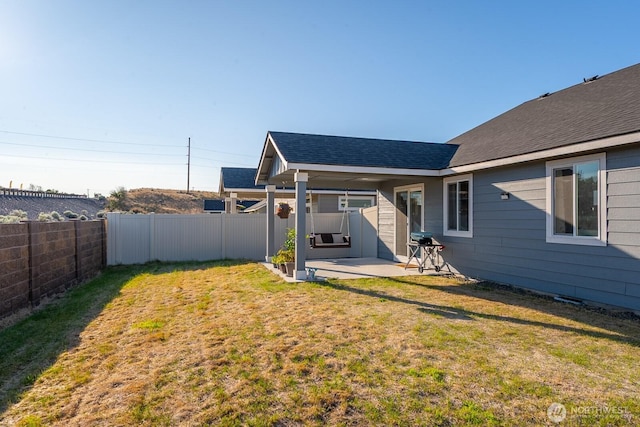 1205 W Sequoia Rd, Moses Lake, WA 98837 - fenced backyard with a patio area