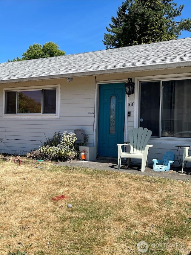 1610 M St NE, Auburn, WA 98002 - doorway to property featuring a shingled roof and a lawn