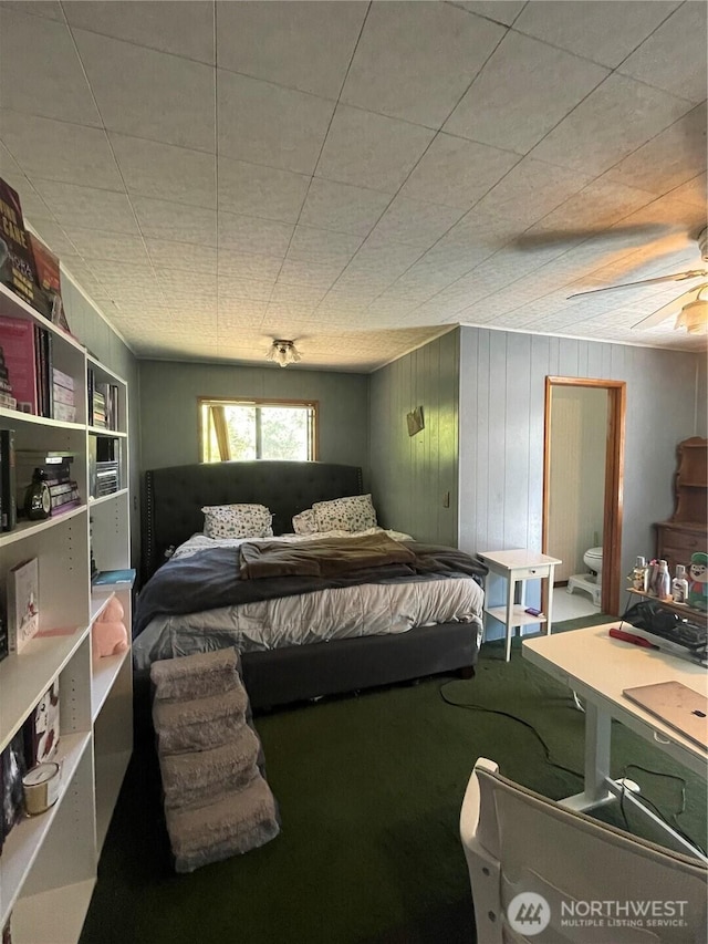 1610 M St NE, Auburn, WA 98002 - bedroom featuring carpet flooring, connected bathroom, and wooden walls