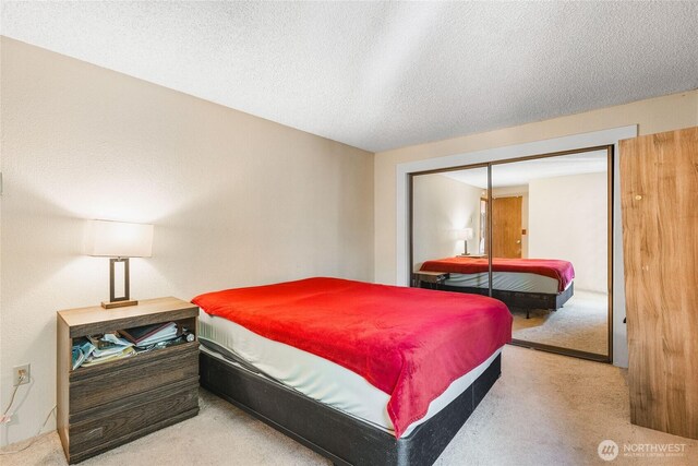7310 N Skyview Ln Unit J-301, Tacoma, WA 98406 - bedroom featuring carpet flooring and a textured ceiling