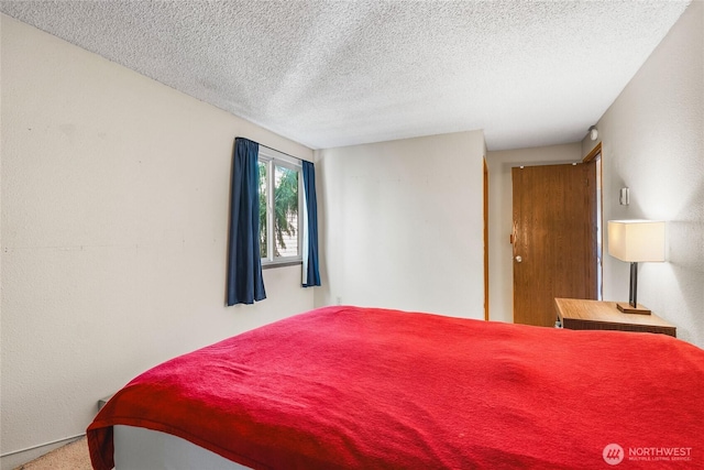 7310 N Skyview Ln Unit J-301, Tacoma, WA 98406 - bedroom with a textured ceiling and carpet floors