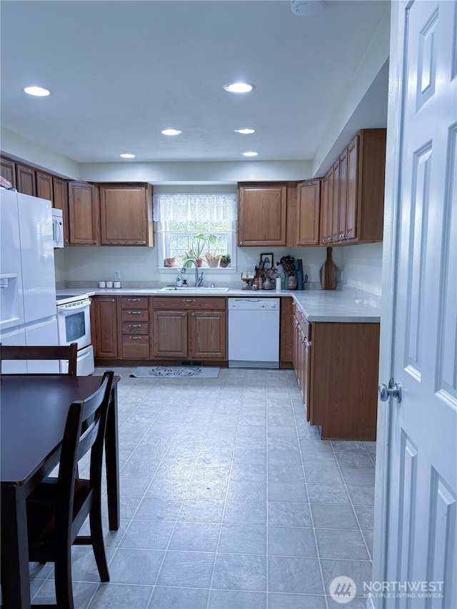 8389 SW Harmon St, Port Orchard, WA 98367 - kitchen with white appliances, light countertops, recessed lighting, brown cabinets, and light tile patterned floors