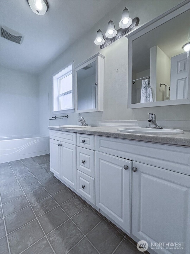 8389 SW Harmon St, Port Orchard, WA 98367 - full bathroom with double vanity, tile patterned floors, a shower with shower curtain, and a tub