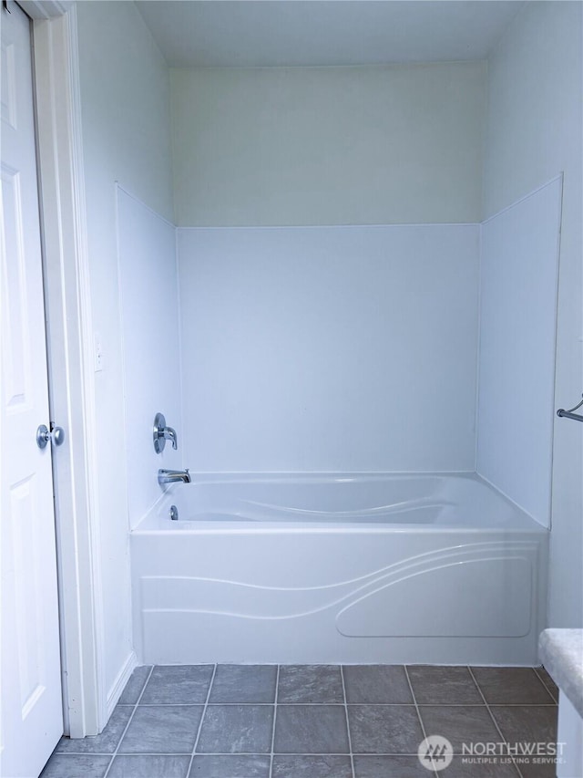 8389 SW Harmon St, Port Orchard, WA 98367 - bathroom with a tub and tile patterned flooring