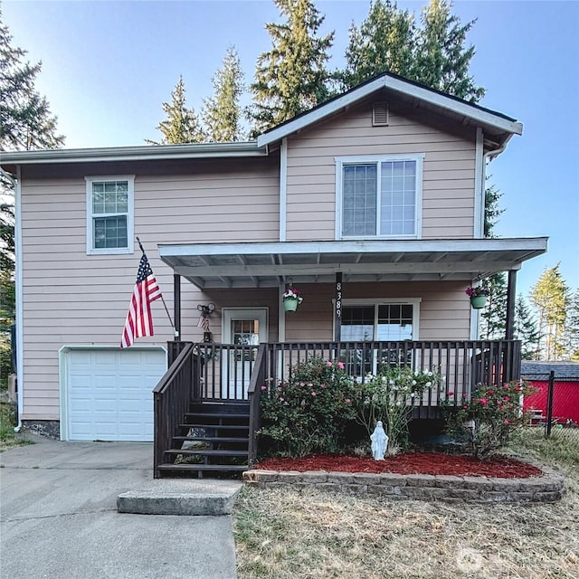 8389 SW Harmon St, Port Orchard, WA 98367 - view of front of house featuring a garage, a porch, and driveway