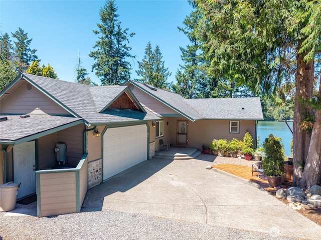 21945 Promontory Ct SE, Yelm, WA 98597 - ranch-style home with a garage, roof with shingles, driveway, and stone siding