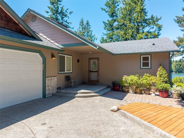 21945 Promontory Ct SE, Yelm, WA 98597 - property entrance featuring a shingled roof and an attached garage