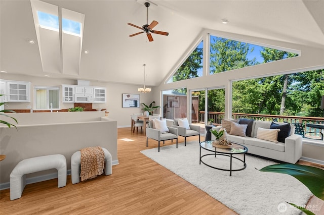 21945 Promontory Ct SE, Yelm, WA 98597 - living area with high vaulted ceiling, light wood-type flooring, plenty of natural light, ceiling fan, and a chandelier