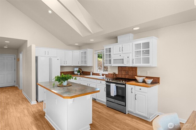 21945 Promontory Ct SE, Yelm, WA 98597 - kitchen featuring white appliances, light wood finished floors, white cabinetry, recessed lighting, and high vaulted ceiling