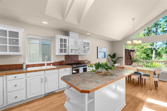 21945 Promontory Ct SE, Yelm, WA 98597 - kitchen with stainless steel electric range, white microwave, light wood finished floors, white cabinetry, and recessed lighting