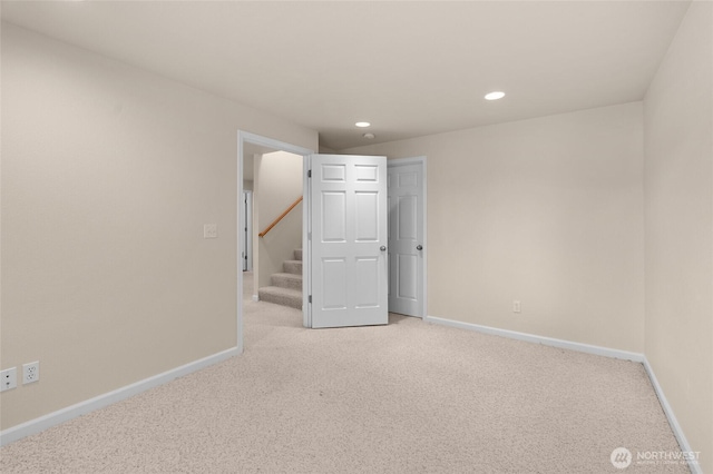 21945 Promontory Ct SE, Yelm, WA 98597 - spare room featuring light colored carpet, recessed lighting, and stairway