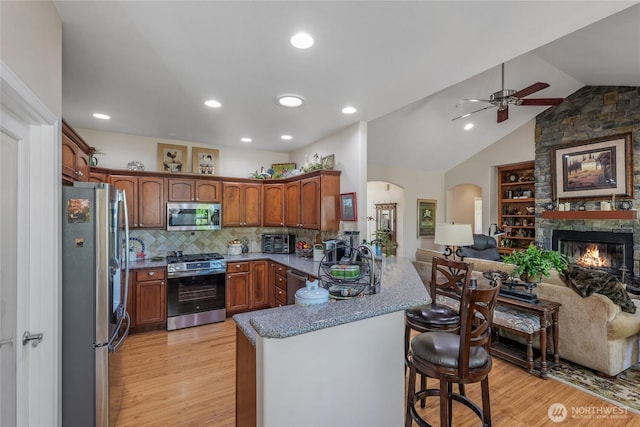 461 Klahhane Rd, Sequim, WA 98382 - kitchen featuring appliances with stainless steel finishes, open floor plan, a peninsula, ceiling fan, and light wood-style floors