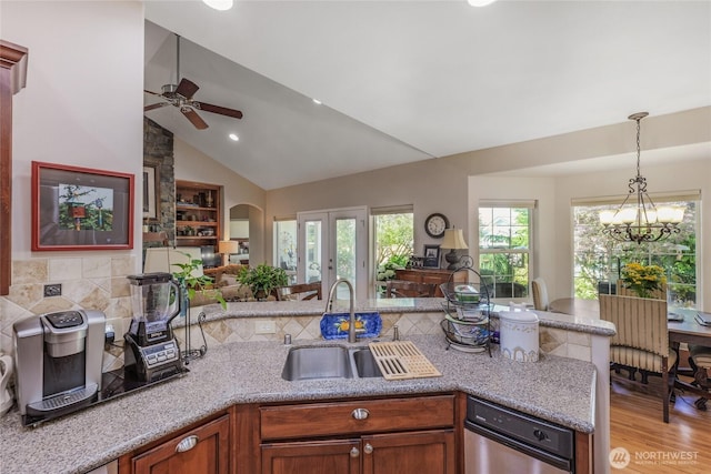 461 Klahhane Rd, Sequim, WA 98382 - kitchen with a ceiling fan, open floor plan, decorative light fixtures, a chandelier, and light stone counters