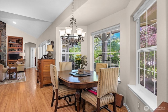 461 Klahhane Rd, Sequim, WA 98382 - dining space with arched walkways, light wood-style floors, a chandelier, and lofted ceiling