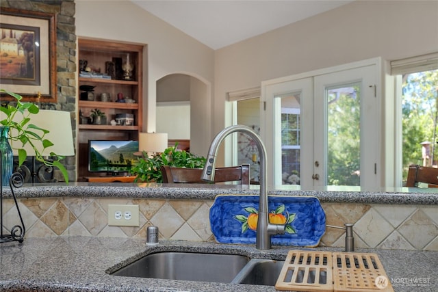 461 Klahhane Rd, Sequim, WA 98382 - kitchen featuring stone countertops, arched walkways, and backsplash