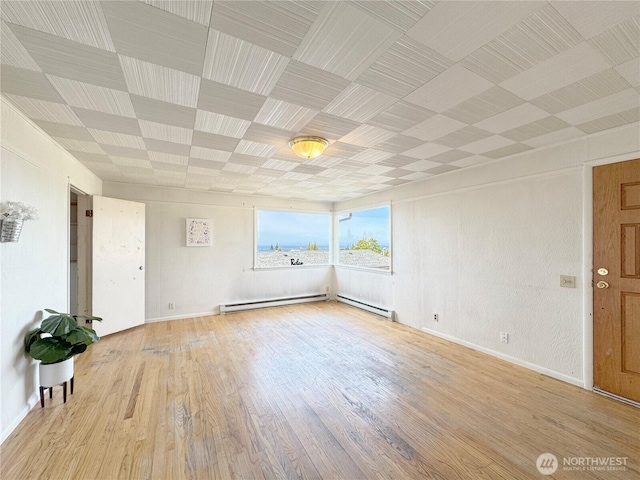 2310 S Laurel St, Port Angeles, WA 98362 - spare room featuring wood finished floors and a baseboard heating unit