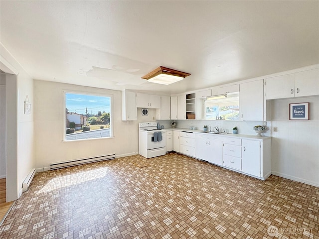 2310 S Laurel St, Port Angeles, WA 98362 - kitchen with white electric range, a baseboard radiator, baseboard heating, light countertops, and white cabinets