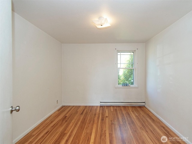 2310 S Laurel St, Port Angeles, WA 98362 - unfurnished room featuring a baseboard radiator and light wood-type flooring