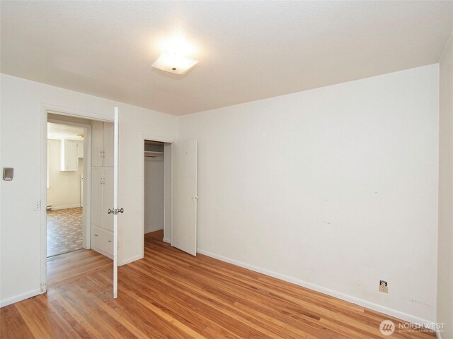 2310 S Laurel St, Port Angeles, WA 98362 - unfurnished bedroom with light wood finished floors and a closet