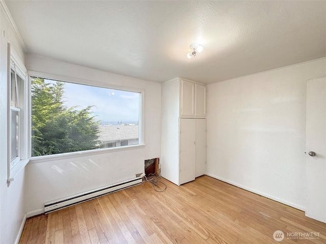 2310 S Laurel St, Port Angeles, WA 98362 - unfurnished bedroom featuring a baseboard heating unit and light wood finished floors