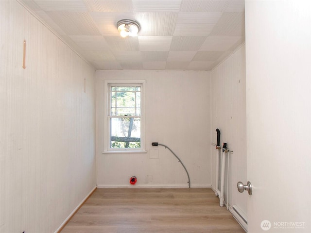 2310 S Laurel St, Port Angeles, WA 98362 - laundry room featuring light wood-style flooring and a baseboard heating unit