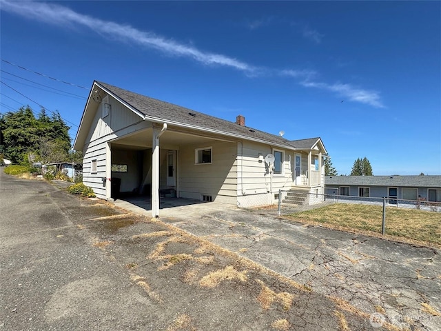 2310 S Laurel St, Port Angeles, WA 98362 - view of front of house with a chimney, a carport, and driveway