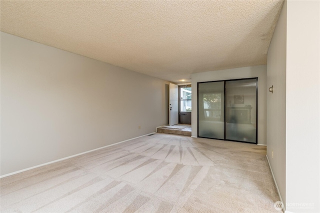 2913 27th St SE, Auburn, WA 98092 - spare room with light colored carpet and a textured ceiling