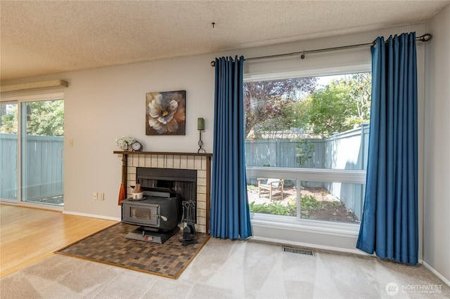 2913 27th St SE, Auburn, WA 98092 - living area featuring a wood stove and a textured ceiling